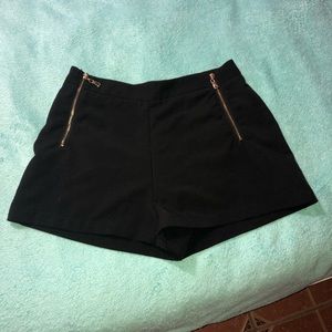 Black shorts with gold zippers
